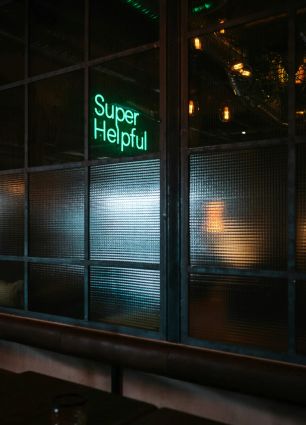 Neon sign that says "Super Helpful"